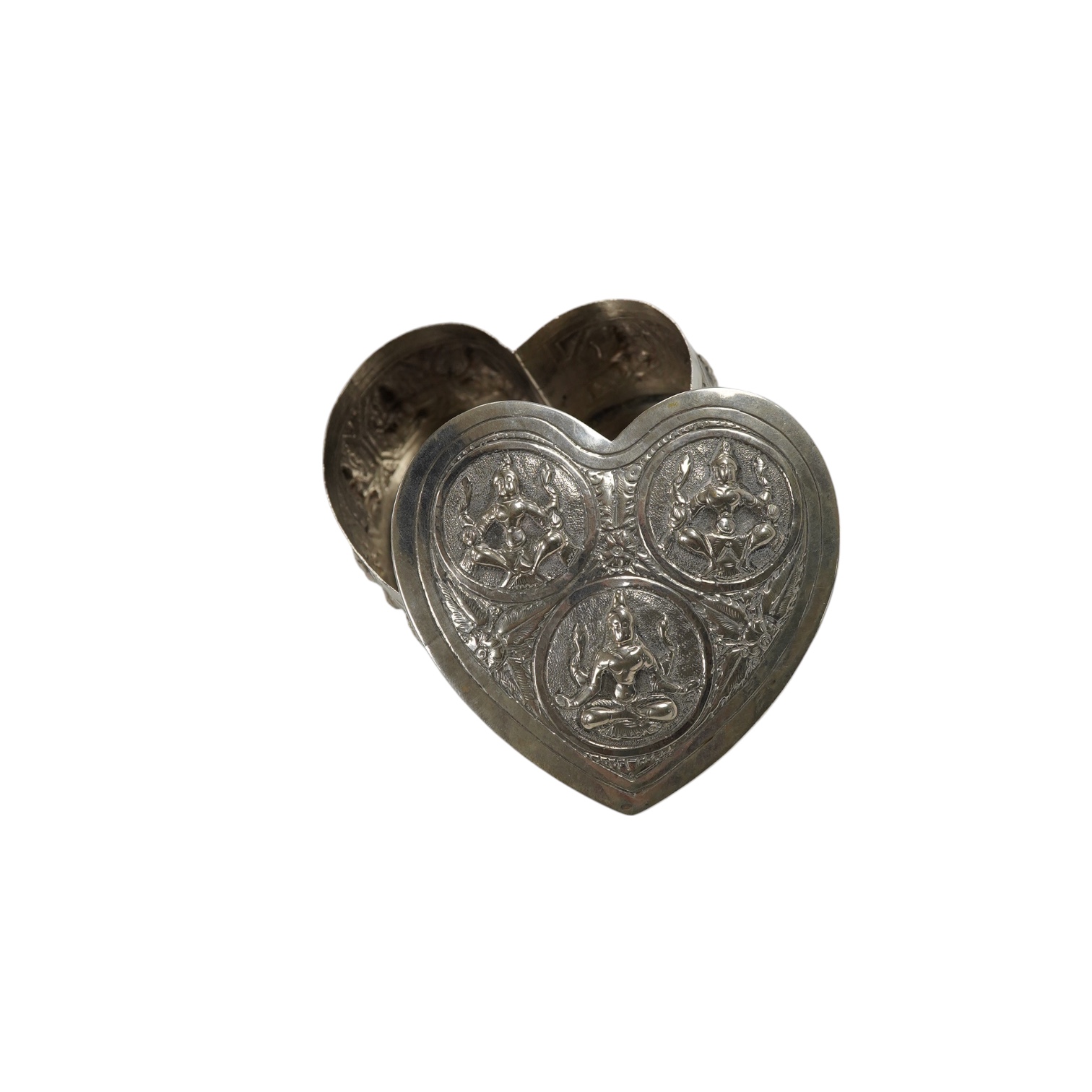 An Indian embossed white metal heart shaped trinket box and cover, width 85mm, 120 grams. Condition - fair